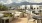 a patio with chairs and tables and a view of a city