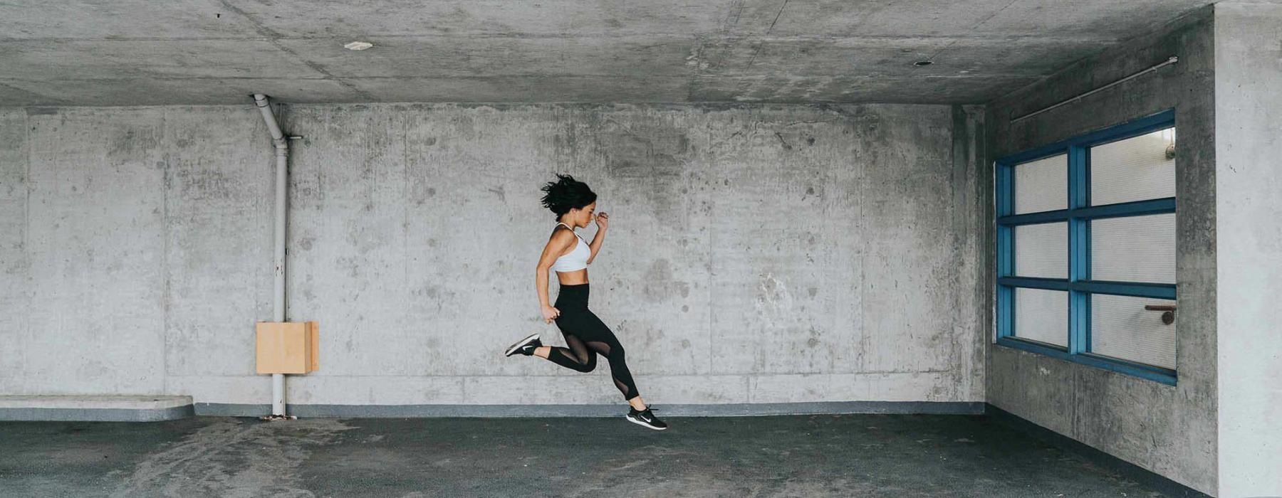 exercising woman caught jumping in mid-air